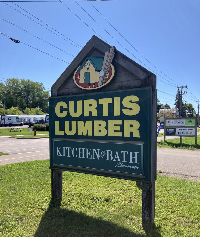 Image shows a sign that reads "Curtis Lumber"