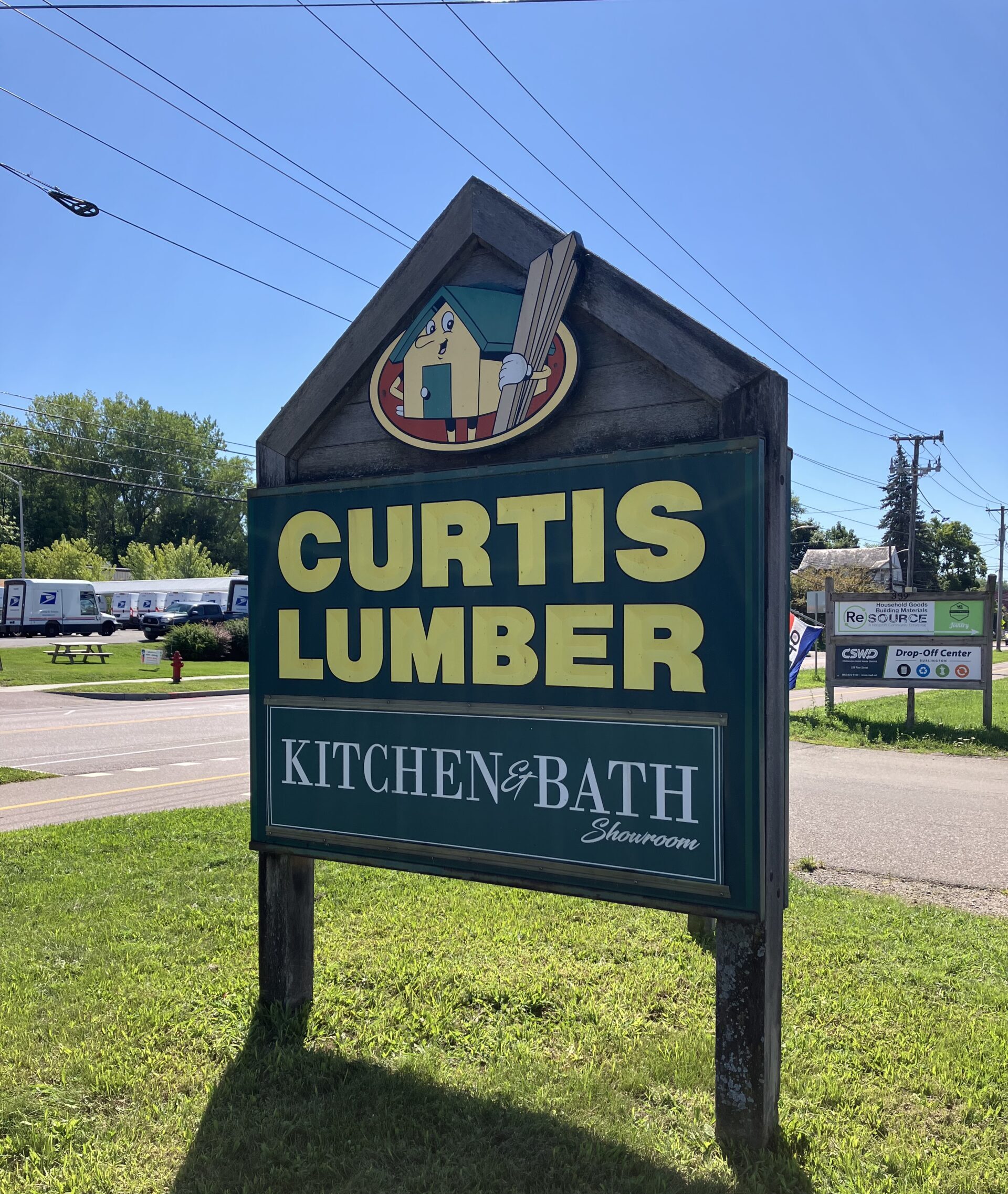 Image shows a sign that reads "Curtis Lumber"
